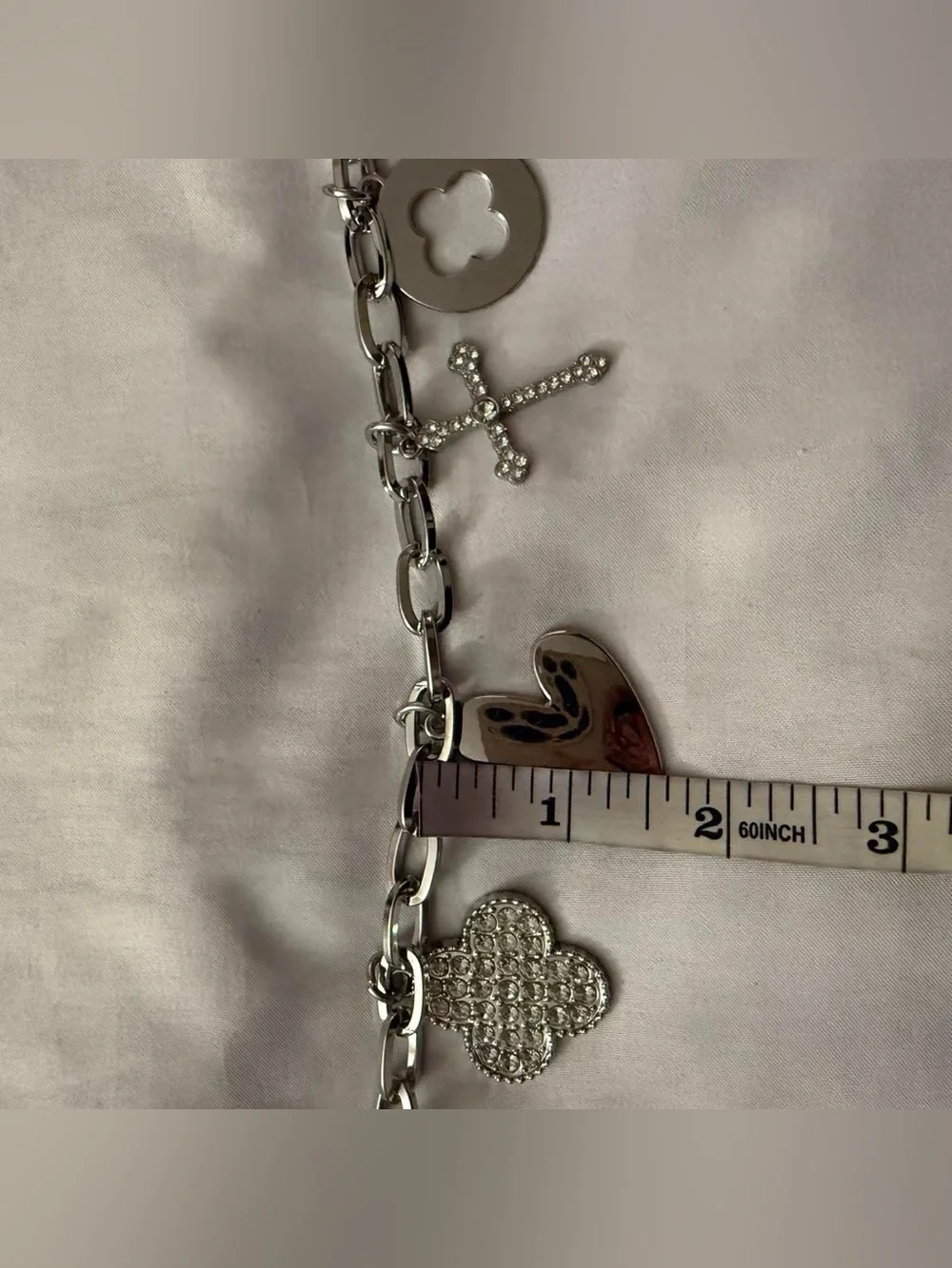 Silver tone metallic charms skinny chain belt